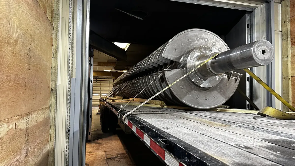 Large coated part loaded on a flatbed truck through a drive-in loading door