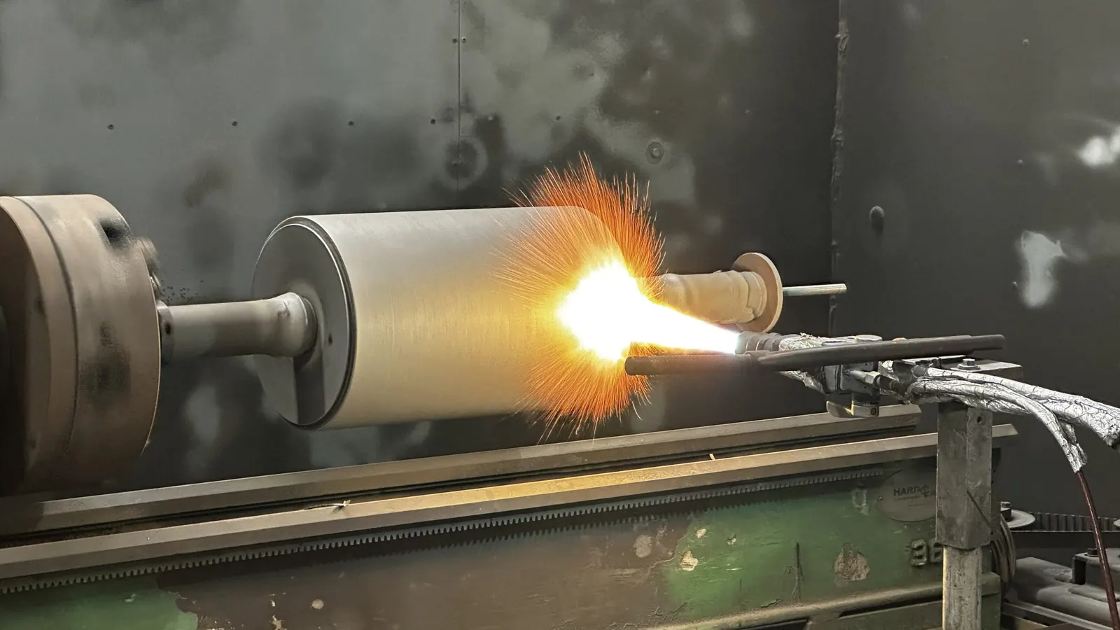 Flame spray coating a roll